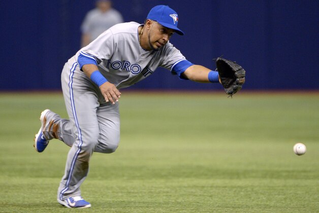 Toronto Blue Jays second baseman Maicer Izturis misses on a line drive single hit by Tampa Bay Rays' Ben Zobrist in the third inning of a baseball game in St. Petersburg, Fla., Thursday, April 3, 2014. (AP Photo/Phelan M. Ebenhack)