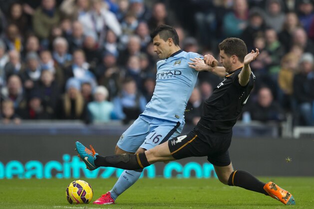 Manchester City's Sergio Aguero, left, fights for the ball against  Hull's Alex Bruce during the English Premier League soccer match between Manchester City and Hull at the Etihad Stadium, Manchester, England, Saturday Feb. 7, 2015. (AP Photo/Jon Super)