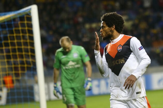 Shakhtar's Luiz Adriano celebrates after scoring against BATE as BATE's goalkeeper Sergei Chernik looks on during their Champions League Group Stage in group H soccer match in Borisov, Belarus, Tuesday, Oct. 21, 2014. (AP Photo/Sergei Grits)