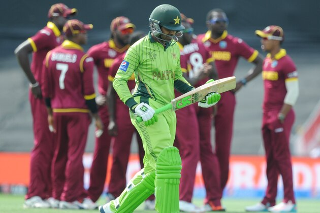 Pakistan batsman Haris Sohai walks from the field as  West Indies players celebrate his dismissal during their Cricket World Cup match in Christchurch, New Zealand, Saturday, Feb. 21, 2015. (AP Photo/Ross Setford)
