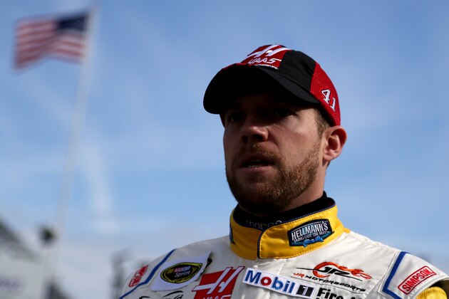 DAYTONA BEACH, FL - FEBRUARY 21:  Regan Smith, driver of the #41 Haas Automation Chevrolet, walks through the garage area during practice for the NASCAR Sprint Cup Series 57th Annual Daytona 500 at Daytona International Speedway on February 21, 2015 in Daytona Beach, Florida. Smith has been named as the replacement driver for Kurt Busch in the #41 Haas Automation Chevrolet for the Daytona 500 on Sunday. Busch was suspended indefinitely by NASCAR after a no-contact order was issued against him for alleged abuse against his ex-girlfriend Patricia Driscoll.  (Photo by Patrick Smith/Getty Images)
