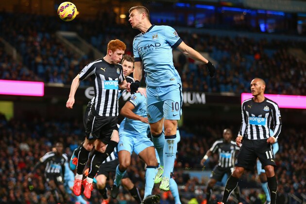 MANCHESTER, ENGLAND - FEBRUARY 21:  Edin Dzeko of Manchester City heads the ball during the Barclays Premier League match between Manchester City and Newcastle United at Etihad Stadium on February 21, 2015 in Manchester, England.  (Photo by Clive Brunskill/Getty Images)
