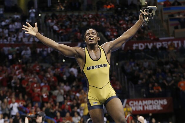 Missouri's J'Den Cox celebrates after defeating Ohio State's Nick Heflin in the 197-pound match in the finals of the NCAA Division I wrestling championships in Oklahoma City, Saturday, March 22, 2014. (AP Photo/Sue Ogrocki)
