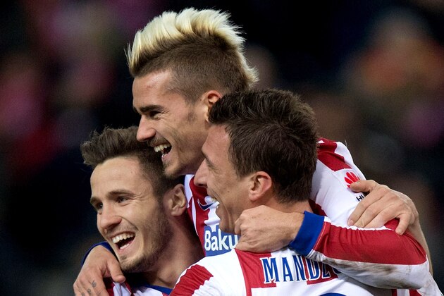 MADRID, SPAIN - FEBRUARY 21: Antoine Griezmann (R) of Atletico de Madrid celebrates scoring their second goal with teammates Mario Mandzukic (2ndR) and Saul Niguez (L) during the La Liga match between Club Atletico de Madrid and UD Almeria at Vicente Calderon Stadium on February 21, 2015 in Madrid, Spain.  (Photo by Gonzalo Arroyo Moreno/Getty Images)