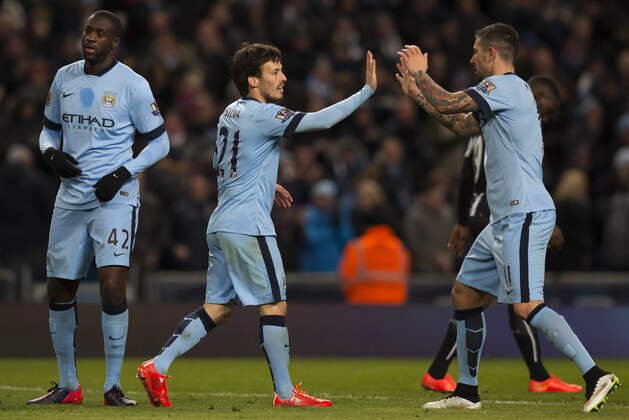 Manchester City's David Silva, centre, celebrates with teammates after scoring his first goal during the English Premier League soccer match between Manchester City and Newcastle at the Etihad Stadium, Manchester, England, Saturday Feb. 21, 2015. (AP Photo/Jon Super)