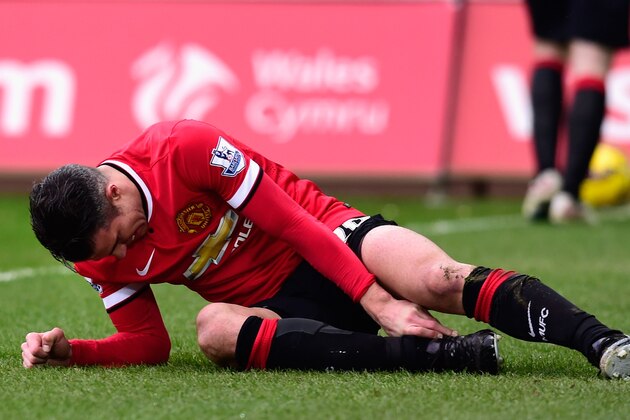 SWANSEA, WALES - FEBRUARY 21:  Robin Van Persie  of Manchester United lies injured during the Barclays Premier League match between Swansea City and Manchester United at Liberty Stadium on February 21, 2015 in Swansea, Wales.  (Photo by Stu Forster/Getty Images)