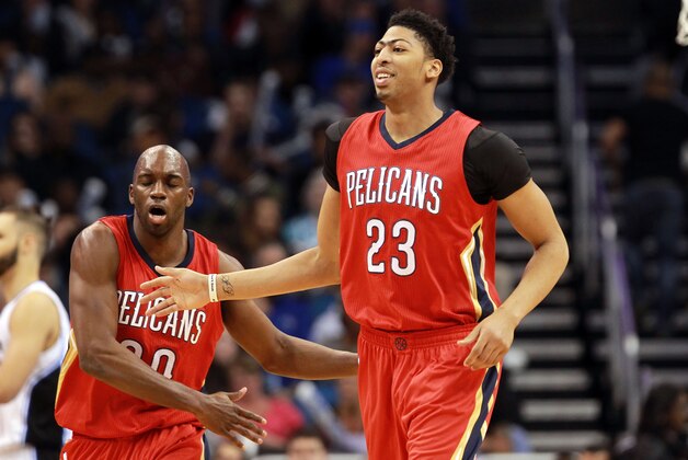 Feb 20, 2015; Orlando, FL, USA; New Orleans Pelicans forward Anthony Davis (23) smiles as he high fives guard Quincy Pondexter (20) after he dunked against the Orlando Magic during the second quarter at Amway Center. Mandatory Credit: Kim Klement-USA TODAY Sports