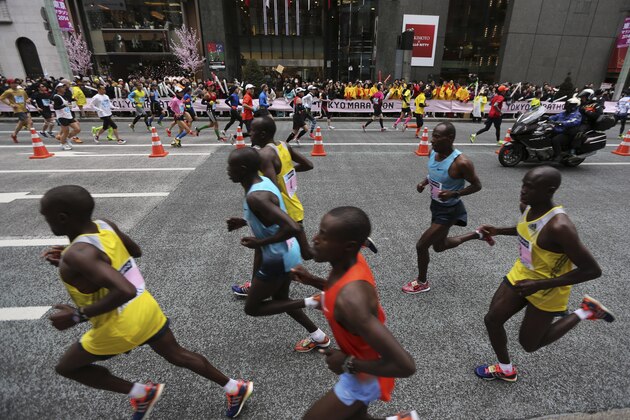 Runners compete during the Tokyo Marathon in Tokyo Sunday, Feb. 23, 2014. (AP Photo/Eugene Hoshiko)