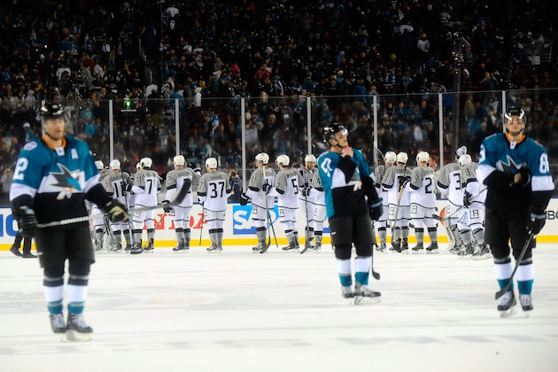 SANTA CLARA, CA - FEBRUARY 21:  (L-R, Foreground) Patrick Marleau #12, Matt Irwin #52 and Melker Karlsson #68 of the San Jose Sharks look on as the Los Angeles Kings celebrate after the 2015 Coors Light NHL Stadium Series game between the Los Angeles Kings and the San Jose Sharks at Levi's Stadium on February 21, 2015 in Santa Clara, California.  The Kings defeated the Sharks 2-1. (Photo by Juan Ocampo/NHLI via Getty Images)
