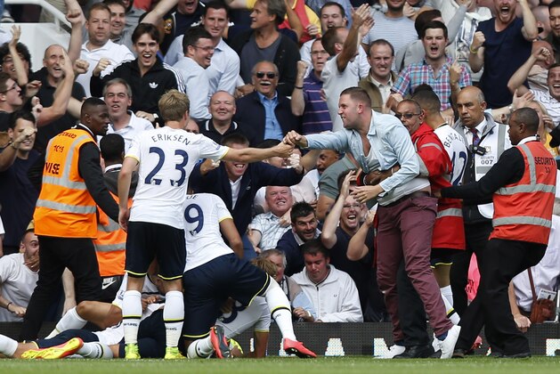 A Tottenham Hotspur's supporter, center right, run onto the pitch to celebrate Eric Dier's goal against West Ham United with the players during their English Premier League soccer match at Upton Park, London, Saturday, Aug. 16, 2014. (AP Photo/Sang Tan) A Tottenham Hotspur's supporter, center right, run onto the pitch to celebrate Eric Dier's goal against West Ham United with the players during their English Premier League soccer match at Upton Park, London, Saturday, Aug. 16, 2014. (AP Photo/Sang Tan)