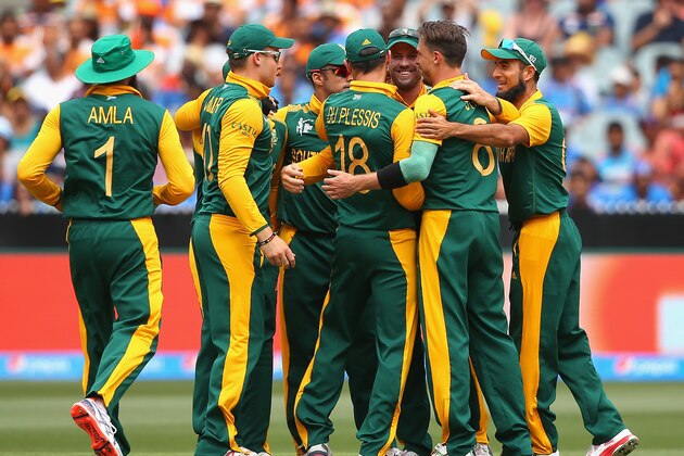 MELBOURNE, AUSTRALIA - FEBRUARY 22:  AB de Villiers of South Africa is congratulated by team mates after running out Rohit Sharma of India during the 2015 ICC Cricket World Cup match between South Africa and India at Melbourne Cricket Ground on February 22, 2015 in Melbourne, Australia.  (Photo by Quinn Rooney/Getty Images)
