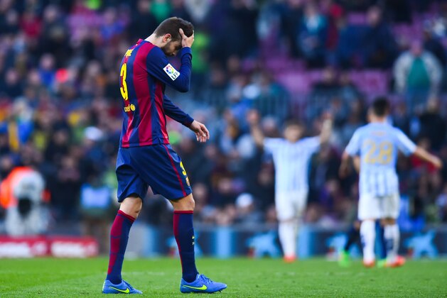 BARCELONA, SPAIN - FEBRUARY 21:  Gerard Pique of FC Barcelona leaves the pitch dejected at the end of the La Liga match between FC Barcelona and Malaga CF at Camp Nou on February 21, 2015 in Barcelona, Spain.  (Photo by David Ramos/Getty Images)