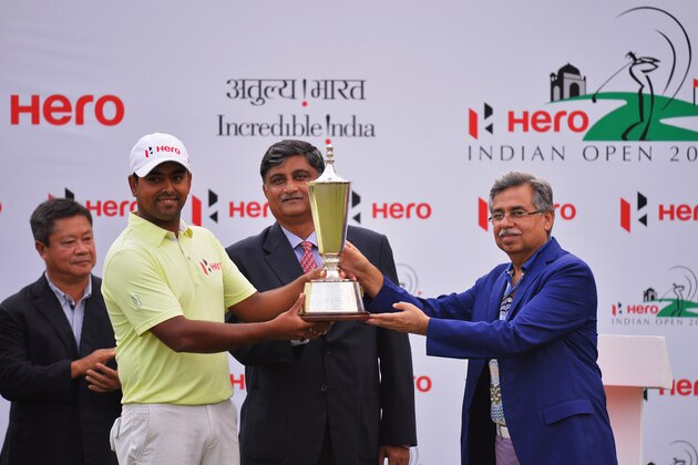 NEW DELHI, INDIA - FEBRUARY 22:  Anirban Lahiri of India recieves the winners trophy from Pawan Munjal, Managing director and CEO of Hero MotoCorp after the Hero India Open Golf at Delhi Golf Club on February 22, 2015 in New Delhi, India.  (Photo by Stuart Franklin/Getty Images)
