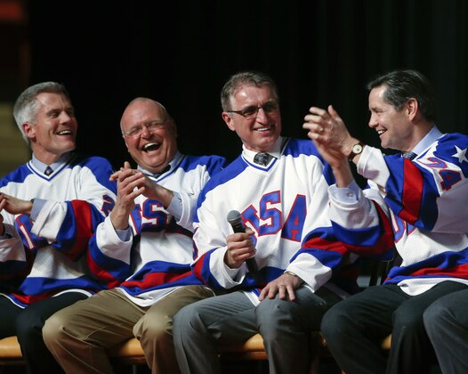 Buzz Schneider of the 1980 U.S. ice hockey team, second from right, speaks during a