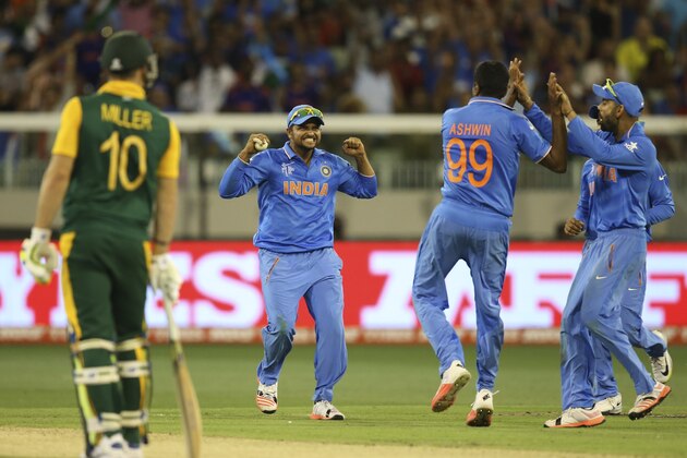Suresh Raina, center and Ravichandran Ashwin, back to camera celebrate the wicket of South Africa's J.P. Duminy during their Cricket World Cup pool B match in Melbourne, Australia, Sunday, Feb. 22, 2015. (AP Photo/Rick Rycroft)
