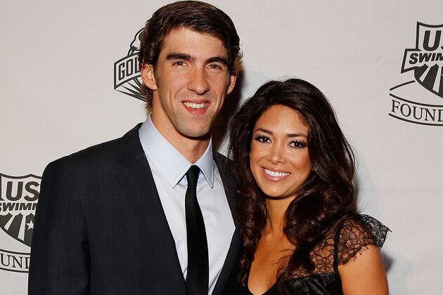 NEW YORK - NOVEMBER 22:  Michael Phelps of the U.S. National Swim Team and Nicole Johnson poses for a photo on the red carpet prior to the 7th Annual Golden Goggle Awards at the Marriott Marquis on November 22, 2010 in New York City.  (Photo by Mike Stobe/Getty Images)