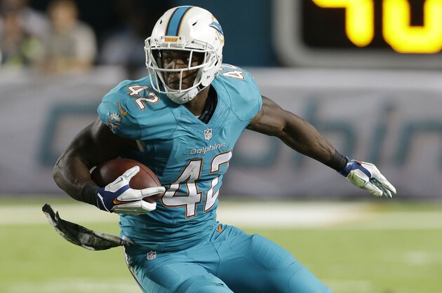 Miami Dolphins tight end Charles Clay (42) looks for room to run while facing the Buffalo Bills during the second half of an NFL football game, Thursday, Nov. 13, 2014 in Miami Gardens, Fla. (AP Photo/Lynne Sladky)
