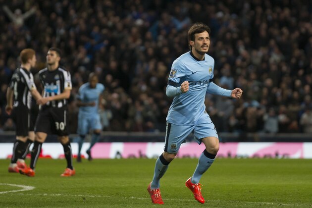 Manchester City's David Silva, right, celebrates after scoring his second goal during the English Premier League soccer match between Manchester City and Newcastle at the Etihad Stadium, Manchester, England, Saturday,  Feb. 21, 2015. (AP Photo / Jon Super)