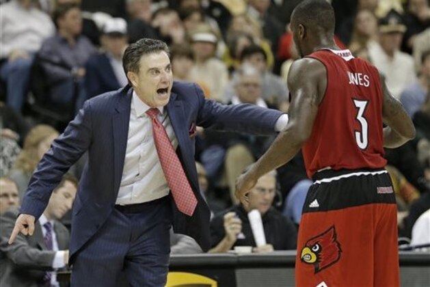 CORRECTS TO WINSTON SALEM-Louisville head coach Rick Pitino, left, shouts at Chris Jones, right, during the second half of an NCAA college basketball game against Wake Forest in Winston Salem, N.C., Sunday, Jan. 4, 2015. Louisville won 85-76. (AP Photo/Chuck Burton)