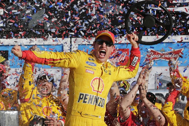 Joey Logano celebrates in Victory Lane after winning the Daytona 500 NASCAR Sprint Cup series auto race at Daytona International Speedway, Sunday, Feb. 22, 2015, in Daytona Beach, Fla. (AP Photo/Chuck Burton)