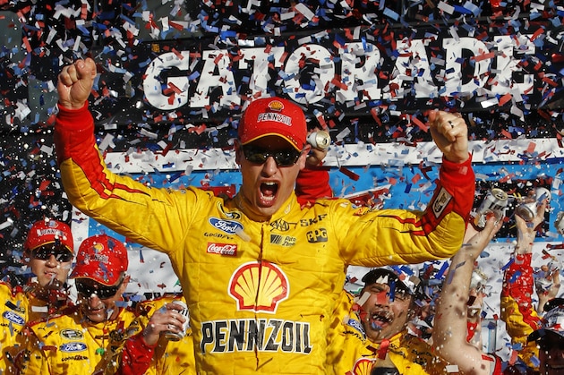 Joey Logano celebrates in Victory Lane after winning the Daytona 500 NASCAR Sprint Cup series auto race at Daytona International Speedway in Daytona Beach, Fla., Sunday, Feb. 22, 2015. (AP Photo/Terry Renna)