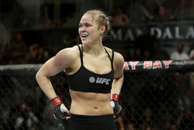 FILE - In this Feb. 22, 2014, file photo, Ronda Rousey looks around after defeating Sara McMann in a UFC 170 mixed martial arts women's bantamweight title bout in Las Vegas. Gina Carano was scheduled to meet with UFC President Dana White on Wednesday April 9, to discuss a return to mixed martial arts for a potential bout with bantamweight champion Rousey. (AP Photo/Isaac Brekken, File)