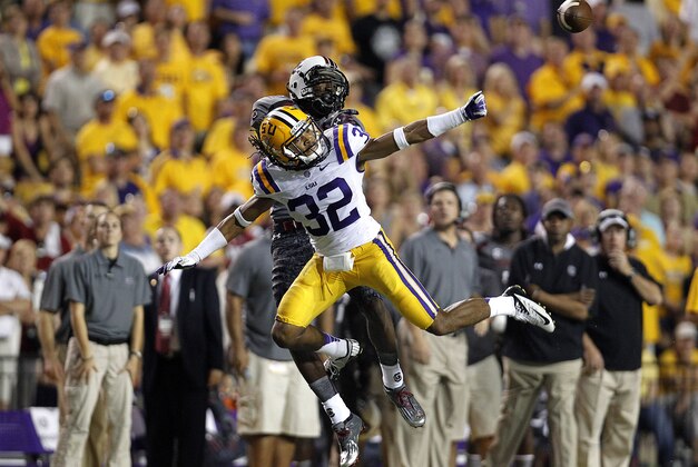LSU cornerback Jalen Collins (32) breaks up a pass intended for South Carolina wide receiver D.L. Moore, background, in the second half of their NCAA college football game in Baton Rouge, La., Saturday, Oct. 13, 2012. LSU won 23-21. (AP Photo/Gerald Herbert)