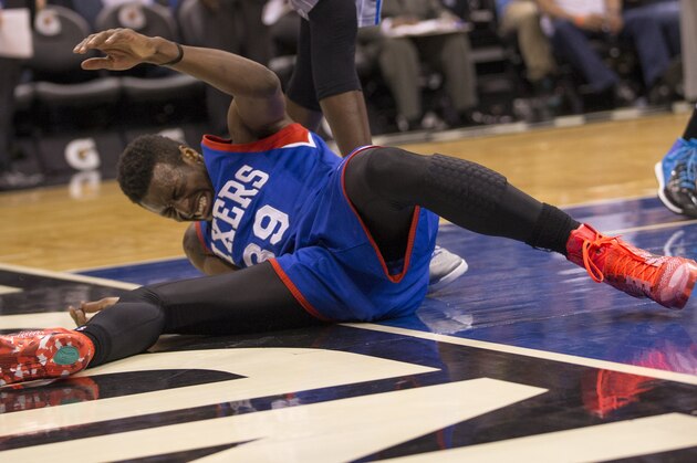 Philadelphia 76ers forward Jerami Grant (39) reacts on the floor after a hard foul by Orlando Magic center Dewayne Dedmon (3) during the first half of an NBA basketball game in Orlando, Fla., Sunday, Feb. 22, 2015. (AP Photo/Willie J. Allen Jr.)