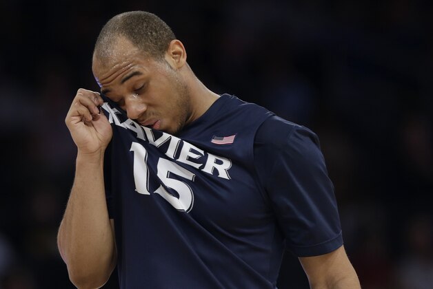 Xavier's Myles Davis (15) wipes his face during the first half of an NCAA college basketball game against Creighton in the semifinals of the Big East Conference men's tournament Friday, March 14, 2014, at Madison Square Garden in New York. (AP Photo/Frank Franklin II)