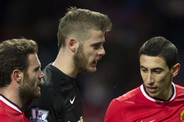 Manchester United's Angel Di Maria, right, congratulates teammates Juan Mata, left, and goalkeeper David De Gea after their 3-1 win during the English Premier League soccer match between Manchester United and Leicester at Old Trafford Stadium, Manchester, England, Saturday Jan. 31, 2015. (AP Photo/Jon Super)