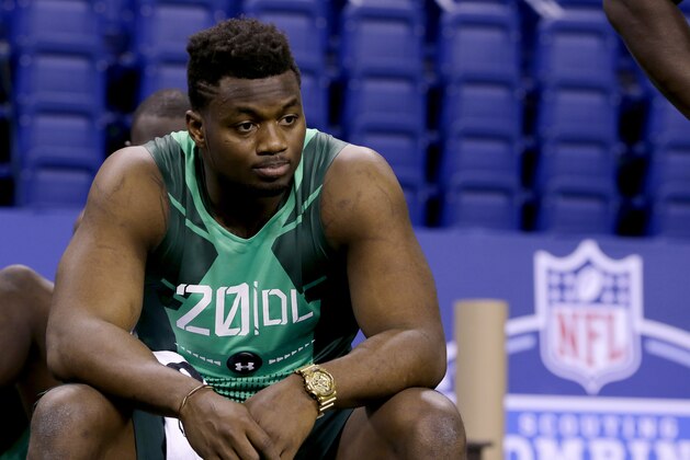 Florida defensive lineman Dante Fowler looks on as prospects are measured at the NFL football scouting combine in Indianapolis, Sunday, Feb. 22, 2015. (AP Photo/Julio Cortez)