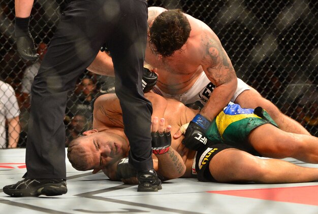 Feb 22, 2015; Porto Alegre, Brazil; Antonio Silva (red gloves) fights against Frank Mir (blue gloves) during UFC Fight Night at Ginasio do Gigantinho. Mandatory Credit: Jason da Silva-USA TODAY Sports
