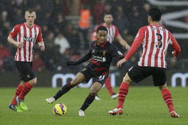 Liverpool’s Raheem Sterling, centre, competes for the ball with Southampton’s Maya Yoshida, right, during the English Premier League soccer match between Southampton and Liverpool at St Mary's Stadium, Southampton, England, Sunday, Feb. 22, 2015. (AP Photo/Tim Ireland)