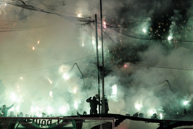 Panathinaikos' fans hold flares during a Greek Super League soccer match against Olympiakos at the Apostolos Nikolaides stadium in Athens, Sunday, Feb.22, 2015. (AP Photo/Yorgos Karahalis)
