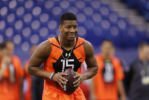 Florida State quarterback Jameis Winston runs a drill at the NFL football scouting combine in Indianapolis, Saturday, Feb. 21, 2015. (AP Photo/Julio Cortez)