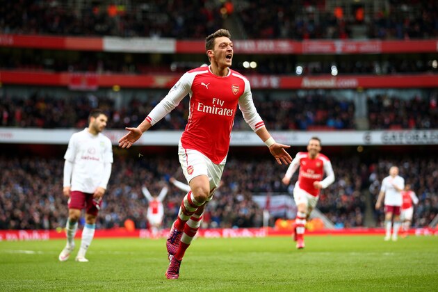 LONDON, ENGLAND - FEBRUARY 01:  Mesut Oezil of Arsenal celebrates after scoring his team's second goal during the Barclays Premier League match between Arsenal and Aston Villa at the Emirates Stadium on February 1, 2015 in London, England.  (Photo by Paul Gilham/Getty Images)