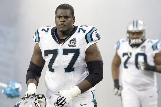 Carolina Panthers' Byron Bell (77) makes his way onto the field followed by teammate Edmund Kugbila (70) before an NFL wild card playoff football game against the Arizona Cardinals in Charlotte, N.C., Saturday, Jan. 3, 2015. The Panthers won 27-16. (AP Photo/Bob Leverone)