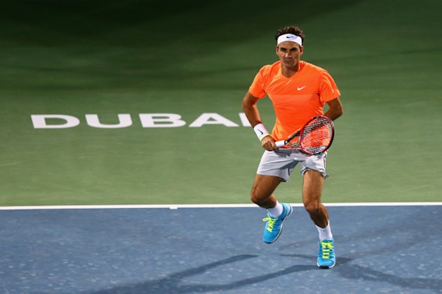 DUBAI, UNITED ARAB EMIRATES - FEBRUARY 23:  Roger Federer of Switzerland in action against Mikhail Youzhny of Russia during day one of the  ATP Dubai Duty Free Tennis Championships at the Dubai Duty Free Stadium on February 23, 2015 in Dubai, United Arab Emirates.  (Photo by Francois Nel/Getty Images)