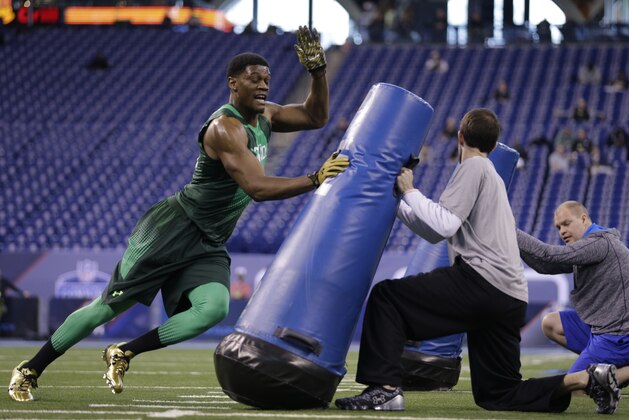 Nebraska defensive lineman Randy Gregory runs a drill at the NFL football scouting combine in Indianapolis, Sunday, Feb. 22, 2015. (AP Photo/David J. Phillip)