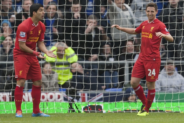 Liverpool's Joe Allen, right, reacts after a missed opportunity as team-mate Luis Suarez stands by during their English Premier League soccer match at Goodison Park Stadium, Liverpool, England, Saturday Nov. 23, 2013. (AP Photo/Jon Super)