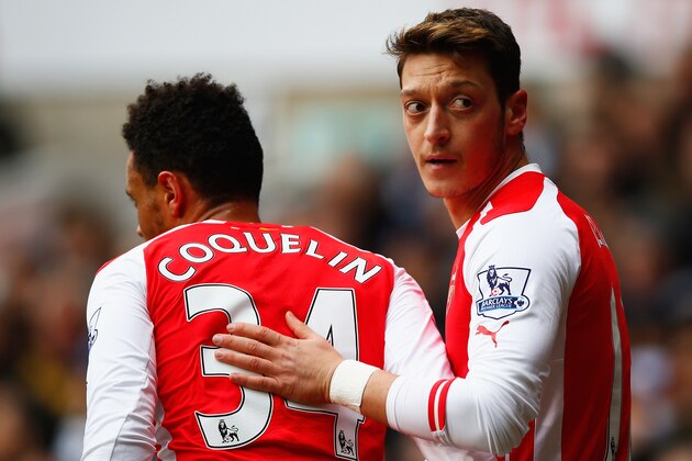 LONDON, ENGLAND - FEBRUARY 07:  Mesut Oezil of Arsenal celebrates scoring the opening goal with Francis Coquelin during the Barclays Premier League match between Tottenham Hotspur and Arsenal at White Hart Lane on February 7, 2015 in London, England.  (Photo by Clive Rose/Getty Images)