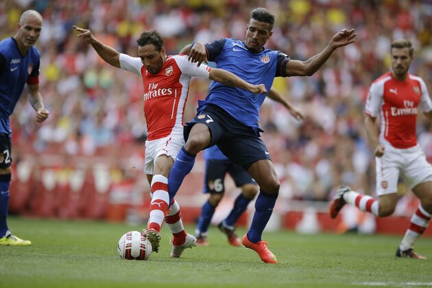 Arsenal's Santi Cazorla, left, competes for the ball with AS Monaco's Nabil Dirar during the Emirates Cup soccer match between Arsenal and AS Monaco at Arsenal's Emirates Stadium in London, Sunday, Aug. 3, 2014.  (AP Photo/Matt Dunham)