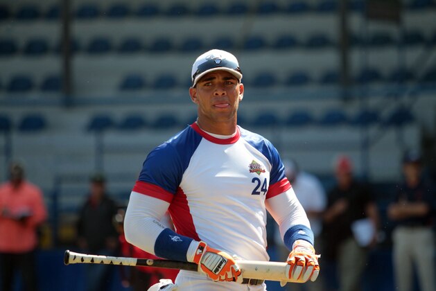 In this Nov. 12, 2014 photo, Cuban baseball player Yoan Moncada prepares for an exhibition game for major league scouts, in the Enrique Torrebiarte Stadium in Guatemala City. (AP Photo/Prensa Libre)