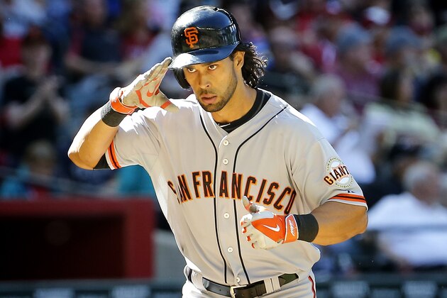 San Francisco Giants Angel Pagan salutes his bench as he rounds the bases after hitting a three run home run against the Arizona Diamondbacks during the eighth inning of an baseball game on Thursday, April 3, 2014,in Phoenix. (AP Photo/Matt York)