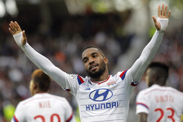 Lyon's Alexandre Lacazette celebrates after scoring the third goal against Lille during their French League One soccer match in Lyon, central France, Sunday, Oct. 5, 2014. (AP Photo/Laurent Cipriani)