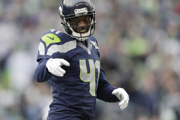 Seattle Seahawks' Byron Maxwell smiles and points to other players between plays against the St. Louis Rams in the first half of an NFL football game, Sunday, Dec. 28, 2014, in Seattle. (AP Photo/John Froschauer)