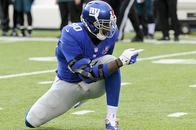 New York Giants' Jason Pierre-Paul (90) reacts to sacking Philadelphia Eagles' Mark Sanchez during the first half of an NFL football game Sunday, Dec. 28, 2014, in East Rutherford, N.J. (AP Photo/Bill Kostroun)