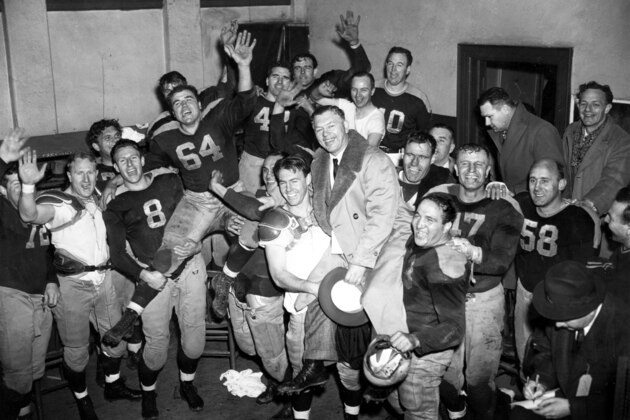 Members of the Green Bay Packers hold a victory celebration in their dressing room after a 14 to 7 win over the New York Giants in the National Football League Championship game in New York, Dec. 17, 1944.  The teammates carry Ted Fritsch (64), who scored the Packers' two touchdowns, and coach E.L.