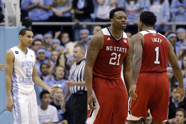 North Carolina State's Beejay Anya (21) and Trevor Lacey (1) react during the first half of an NCAA college basketball game against North Carolina in Chapel Hill, N.C., Tuesday, Feb. 24, 2015. North Carolina State won 58-46.  (AP Photo/Gerry Broome)