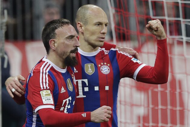 Bayern's Arjen Robben from the Netherlands, right, celebrates with teammate Franck Ribery from France after scoring his side's opening goal during the German first division Bundesliga soccer match between FC Bayern and SC Freiburg in the Allianz Arena in Munich, Germany, on Tuesday, Dec. 16, 2014. (AP Photo/Matthias Schrader)